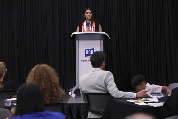 A student speaking at a podium
